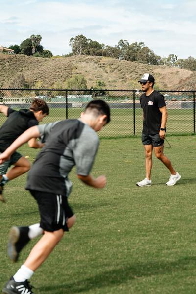 Young athletes sprinting at full speed during a Performance Lab training session