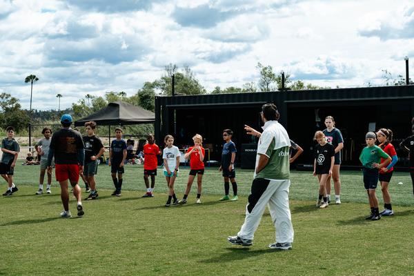 Group warm-up led by a Performance Lab coach at the Speed Camp