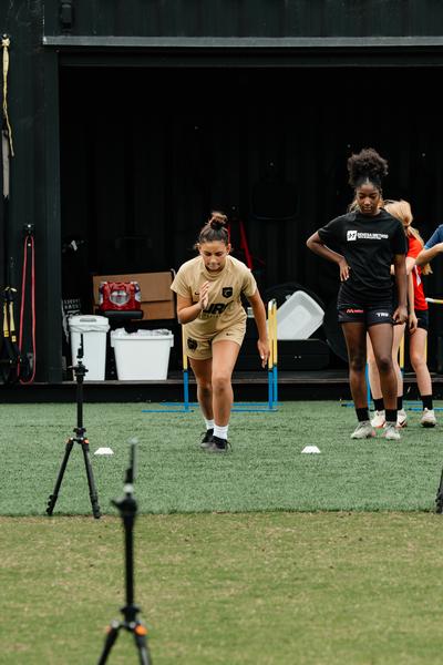 Young athlete performing a broad-jump power test measured on a jump mat